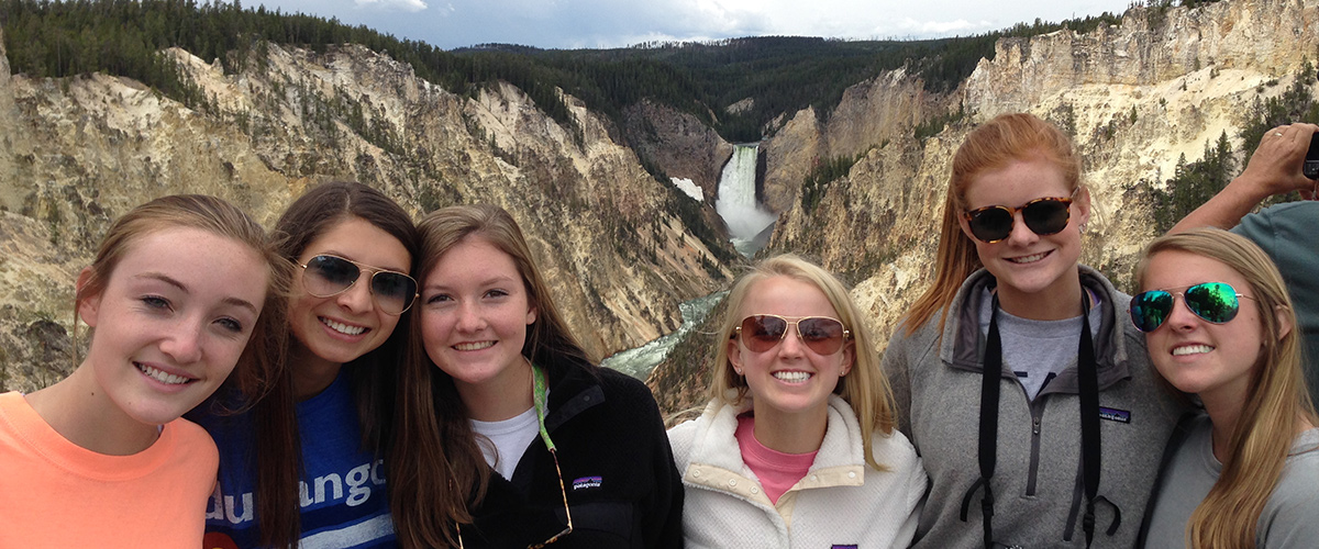 western tour alumni with waterfall