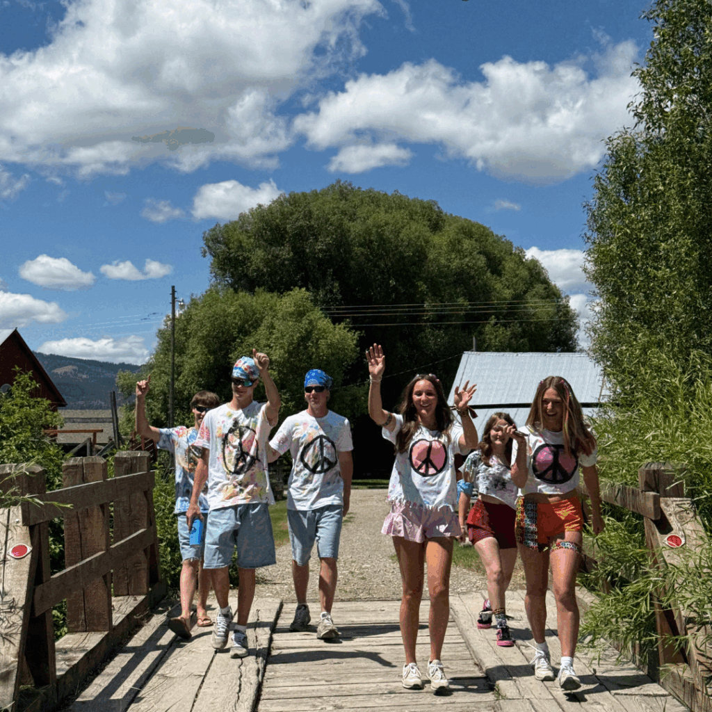 students in a white t shirt walking toward camera 