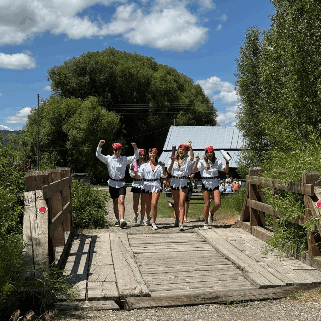 students dressed as pirates walking over bridge 