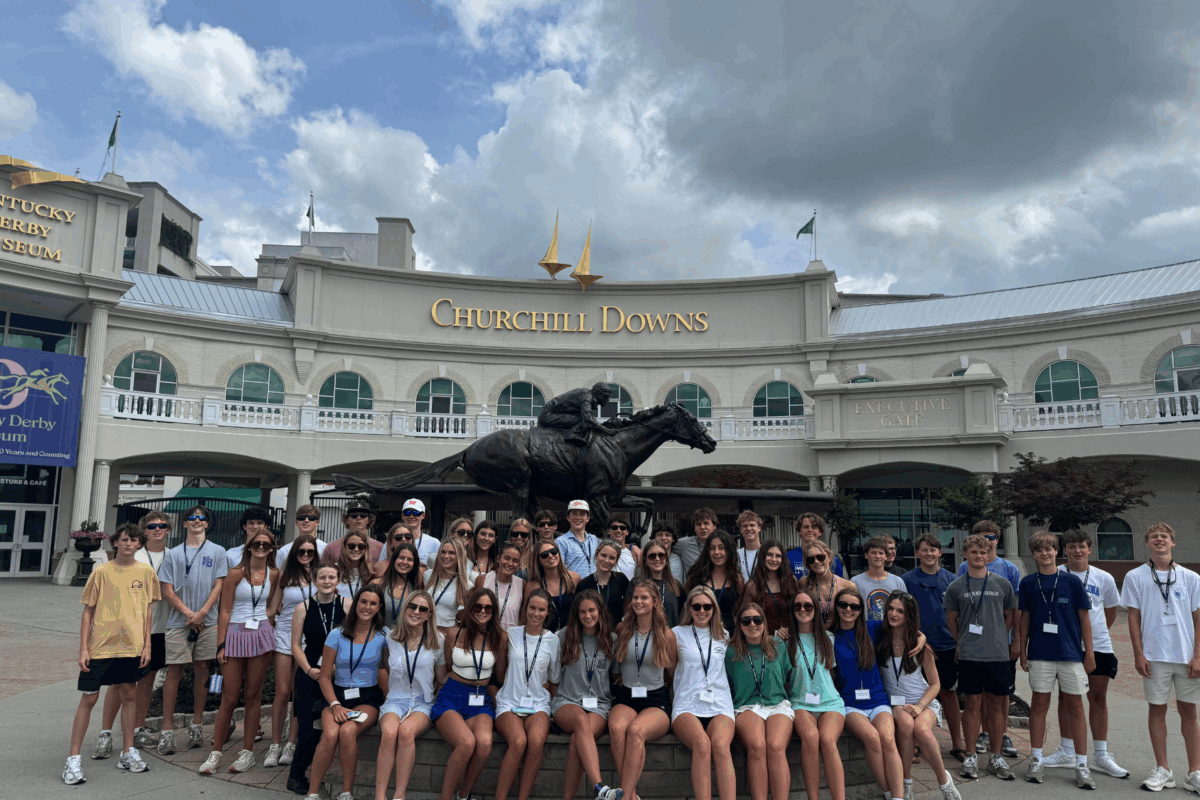 students posing as a group in front of Churchill Downs