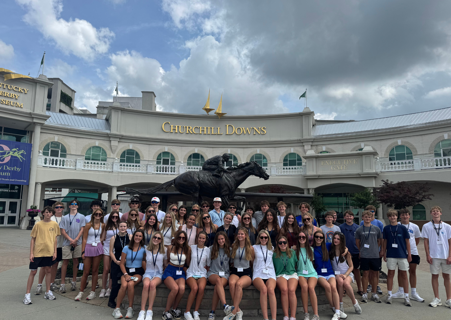 students posing as a group in front of Churchill Downs