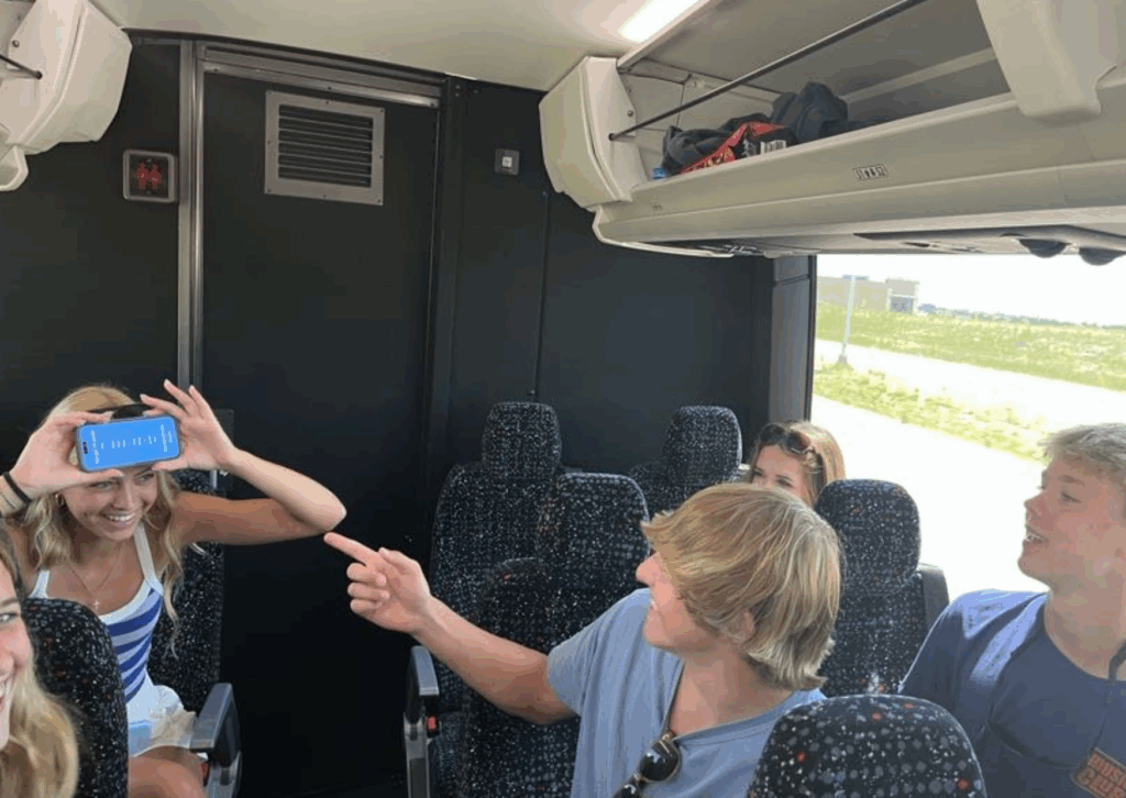 students playing heads up on a phone in the bus 