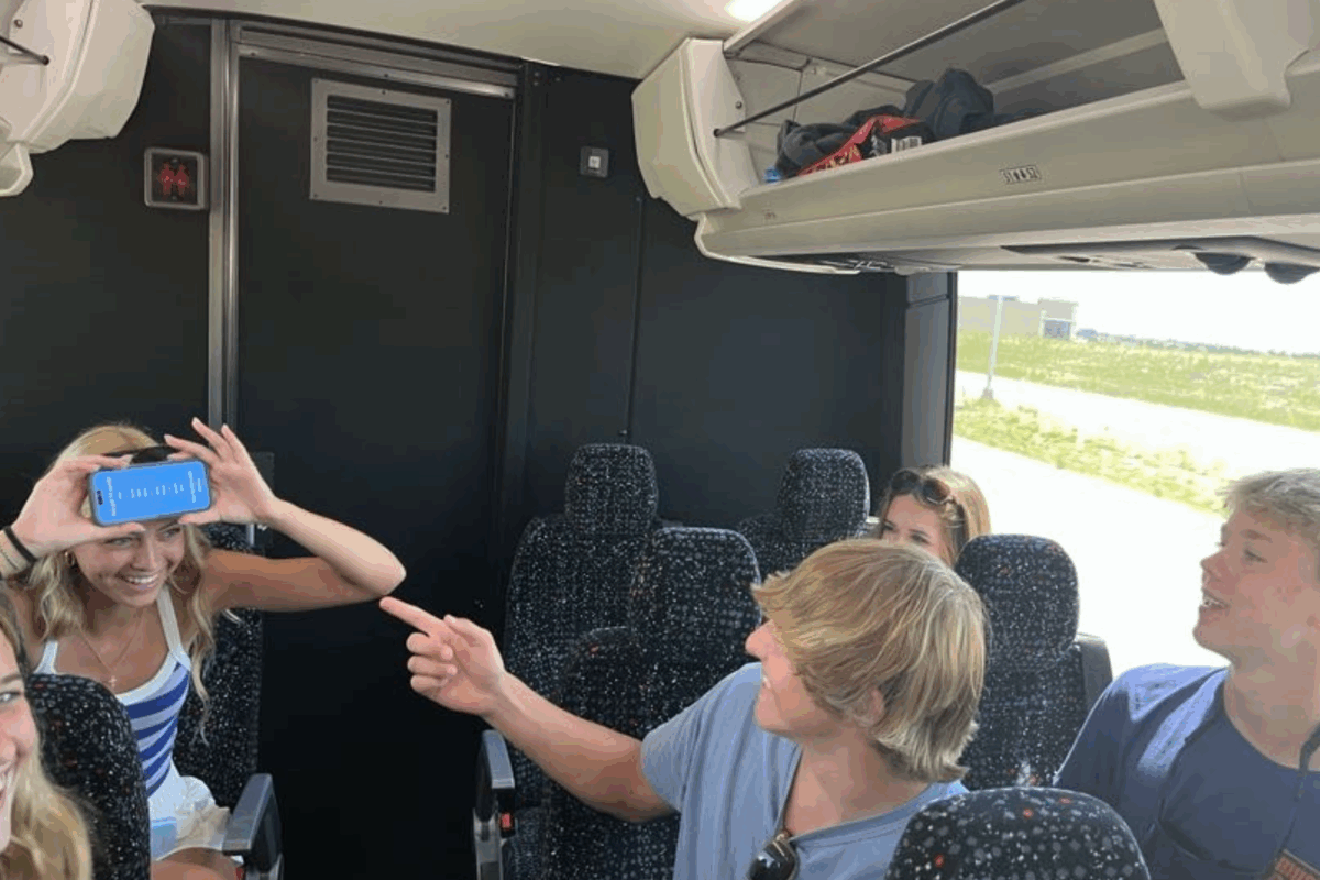 students playing heads up on the bus