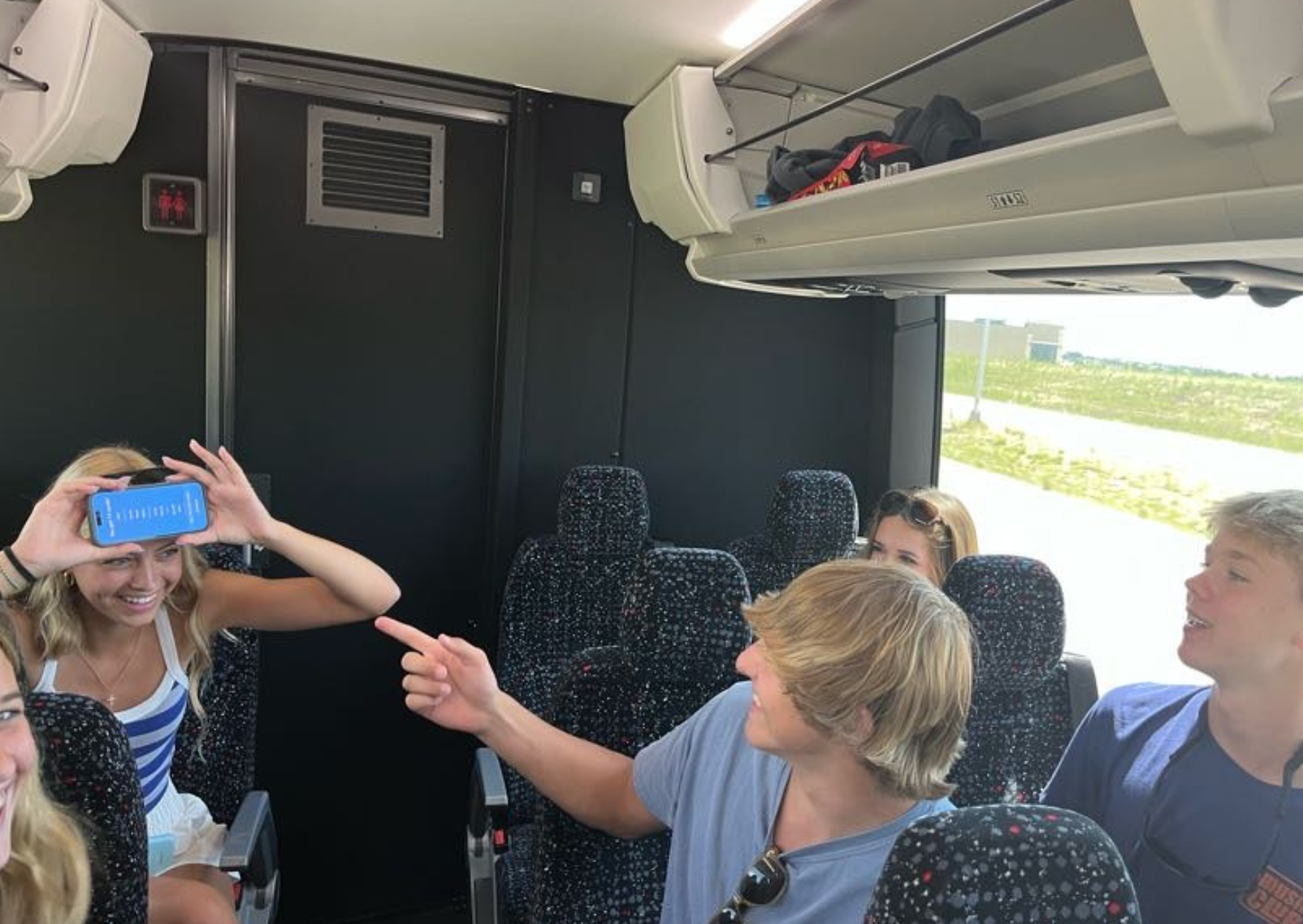 students playing heads up on the bus