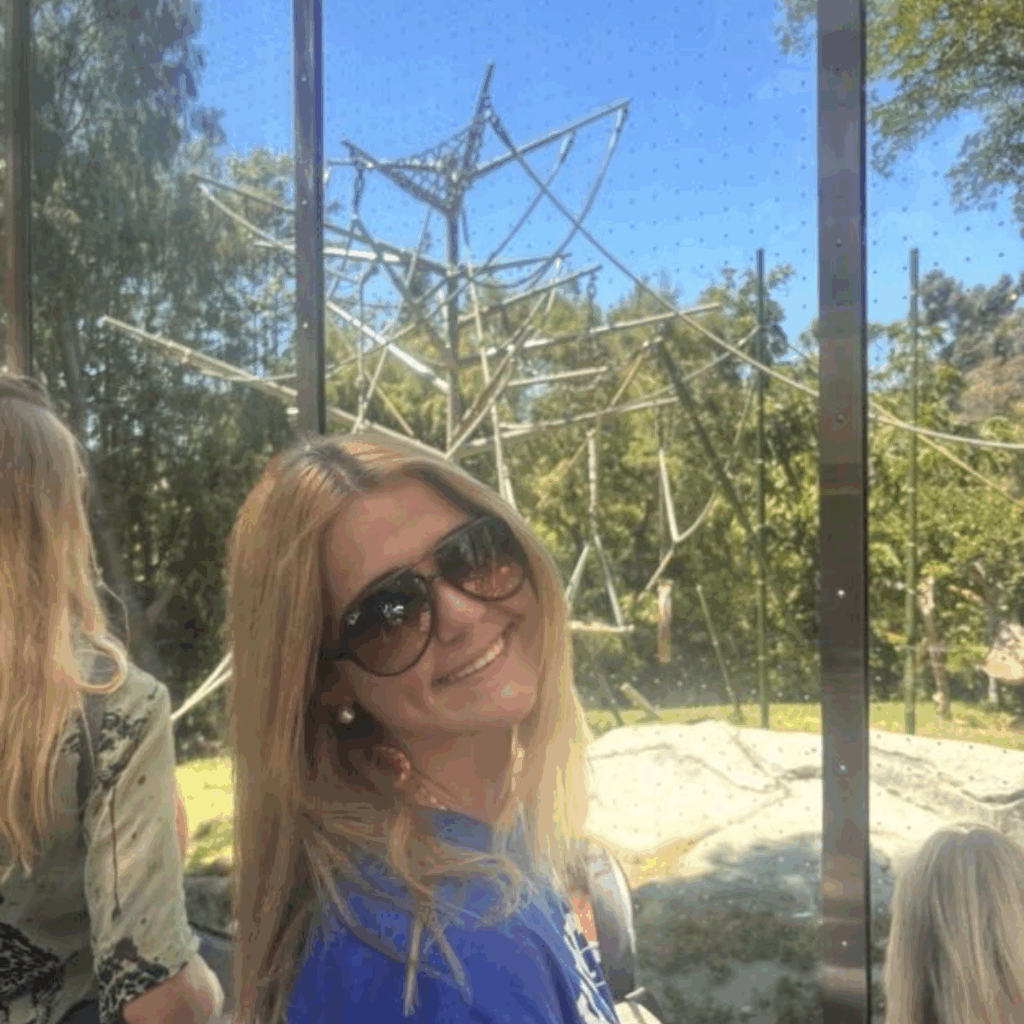 girl looking over her shoulder with sunglasses at the zoo 