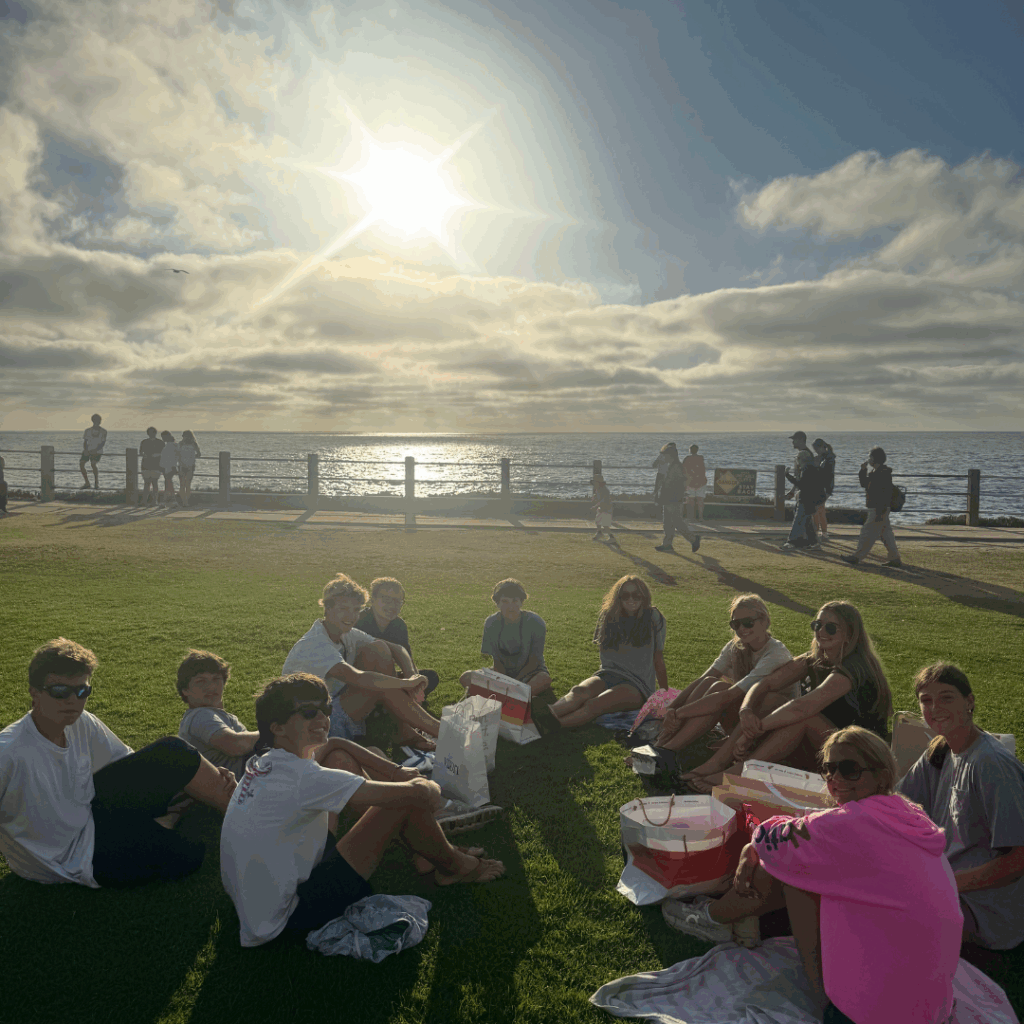 students enjoying the sun sitting in a circle at La Jolla 
