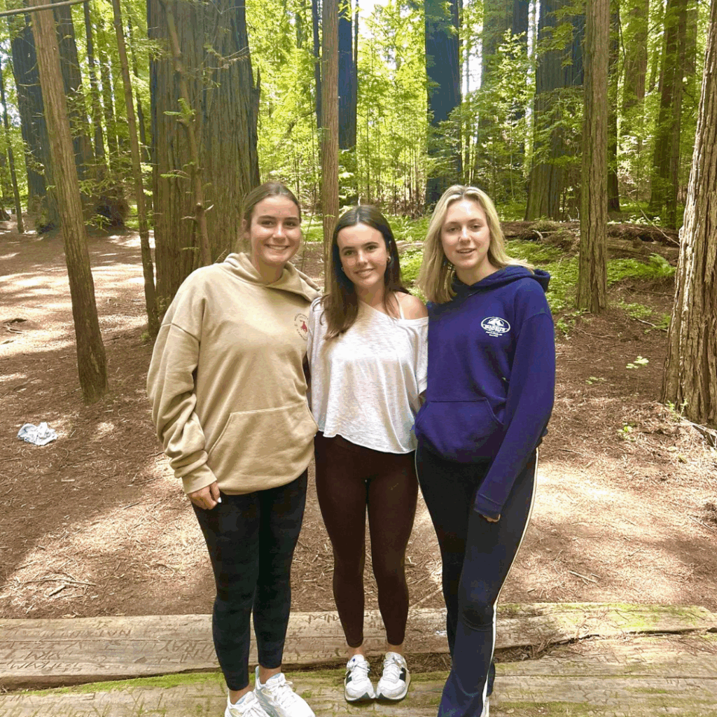 girls three in sweatshirts at the redwoods forest 