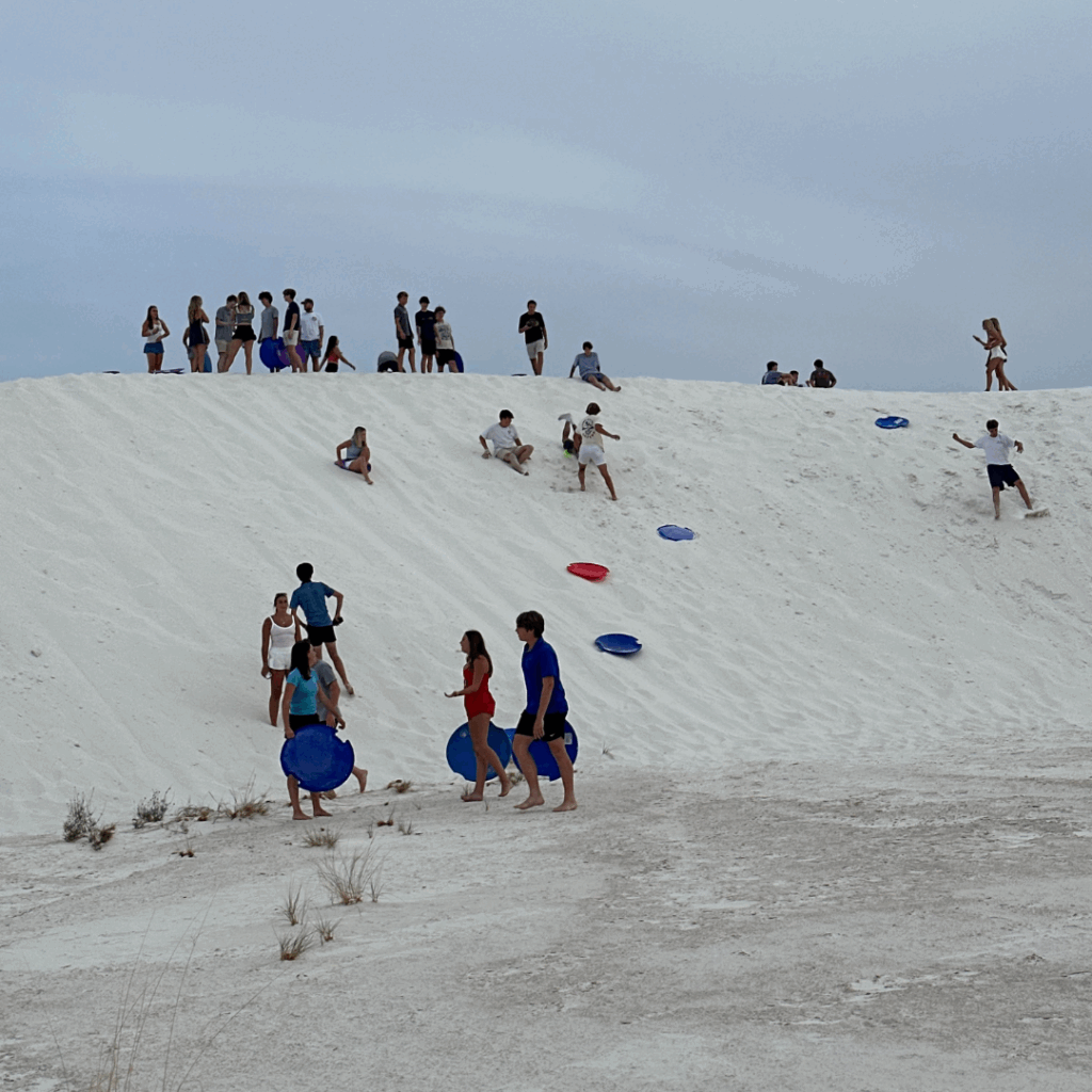 sliding over the dunes at the white sands national park 