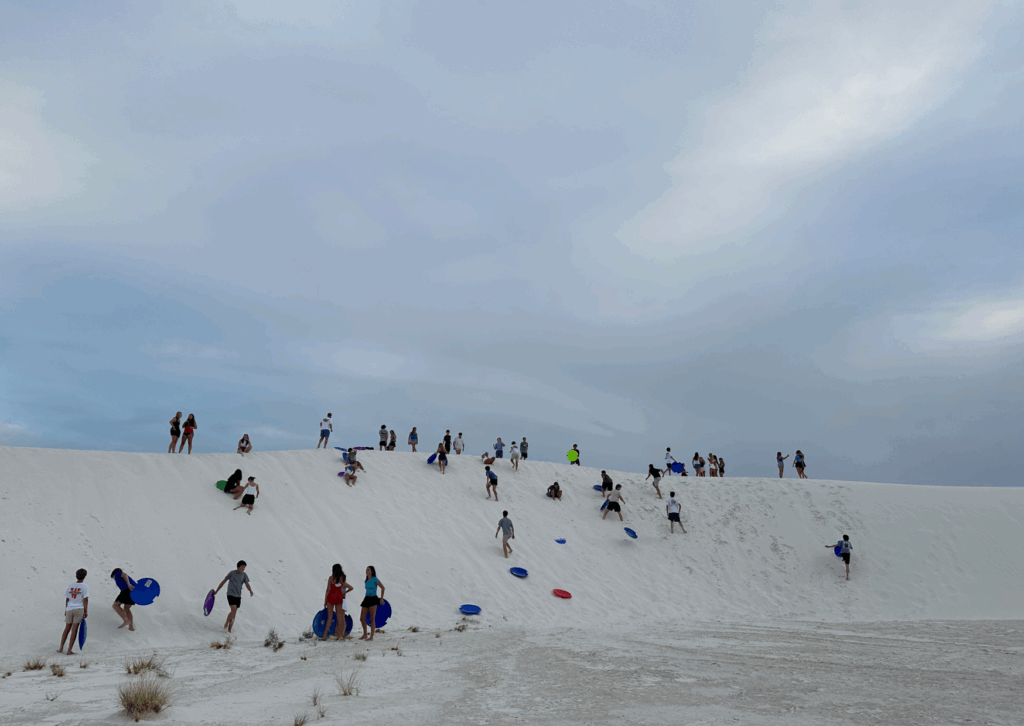 sledding over the dunes at the white sands national park 
