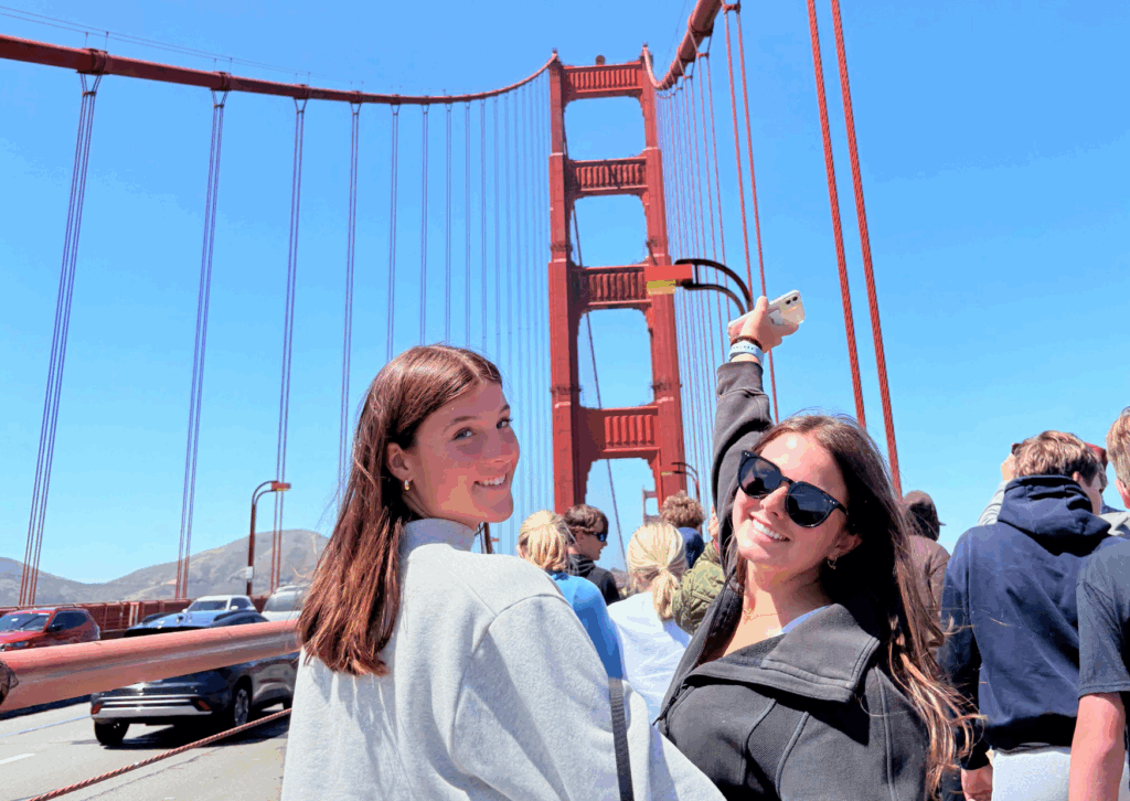 two students looking back on the golden gate bridge