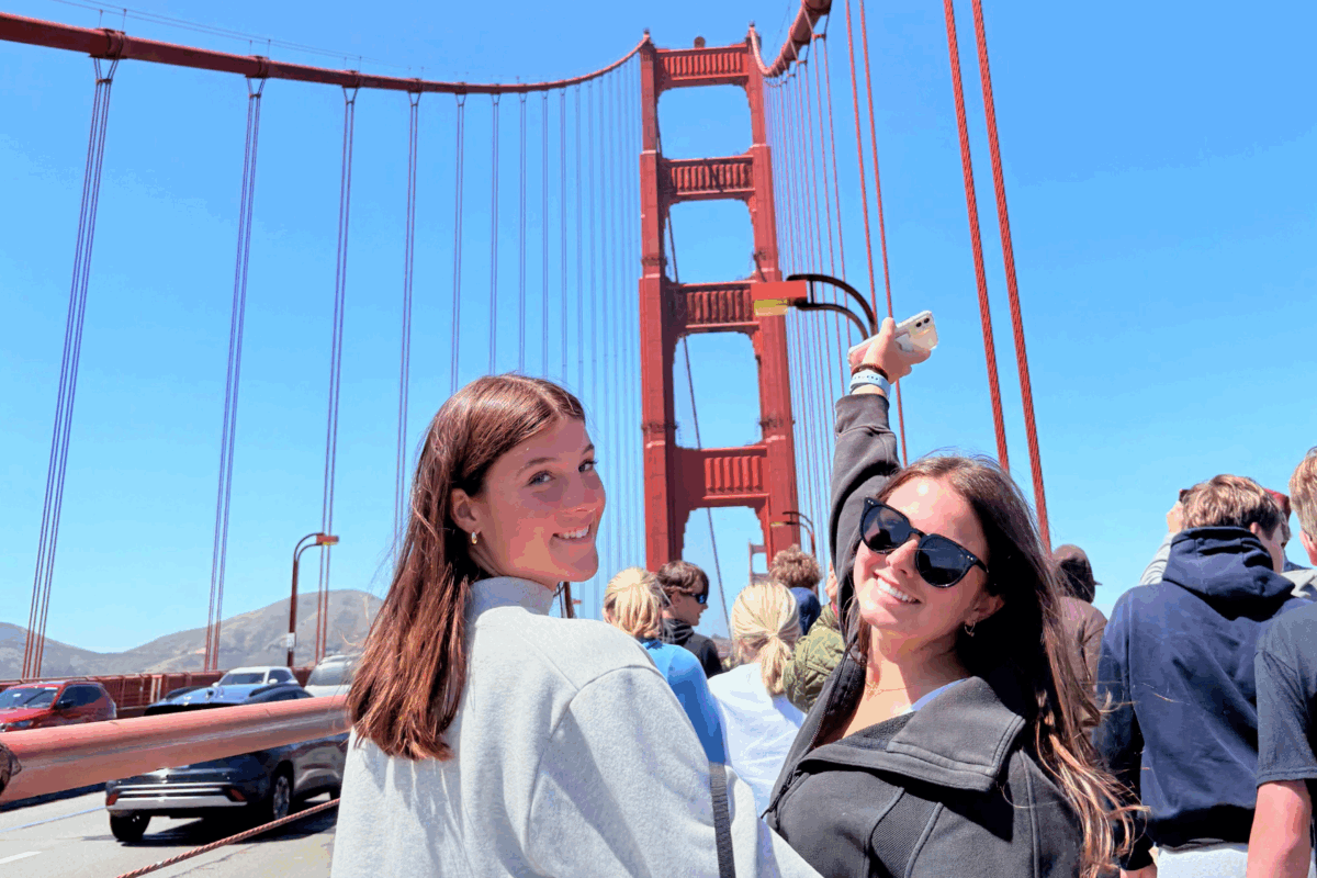two students looking back on the golden gate bridge