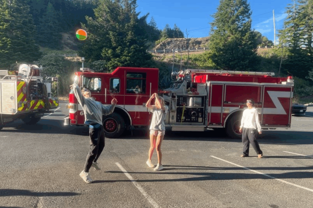 students playing volleyball outside the fire station
