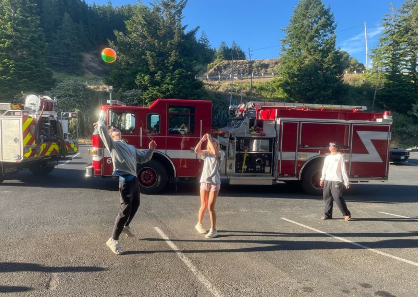 students playing volleyball outside the fire station