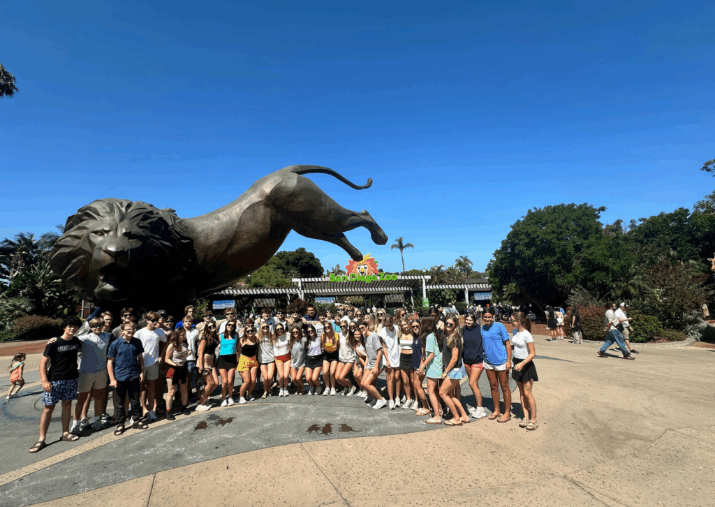 students in a group photo at the entrance of the san diego zoo 