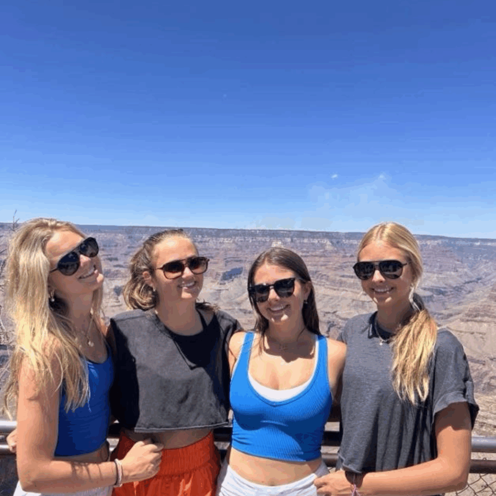 four students standing at the grand canyon