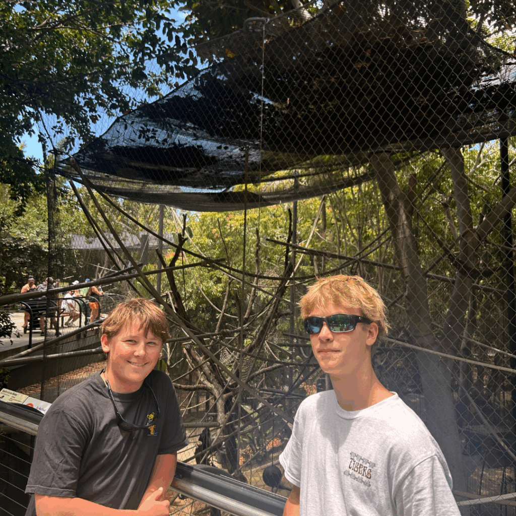 boys posing together at the zoo 
