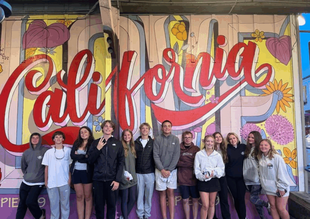 students lined up standing in front of a sign that reads California 