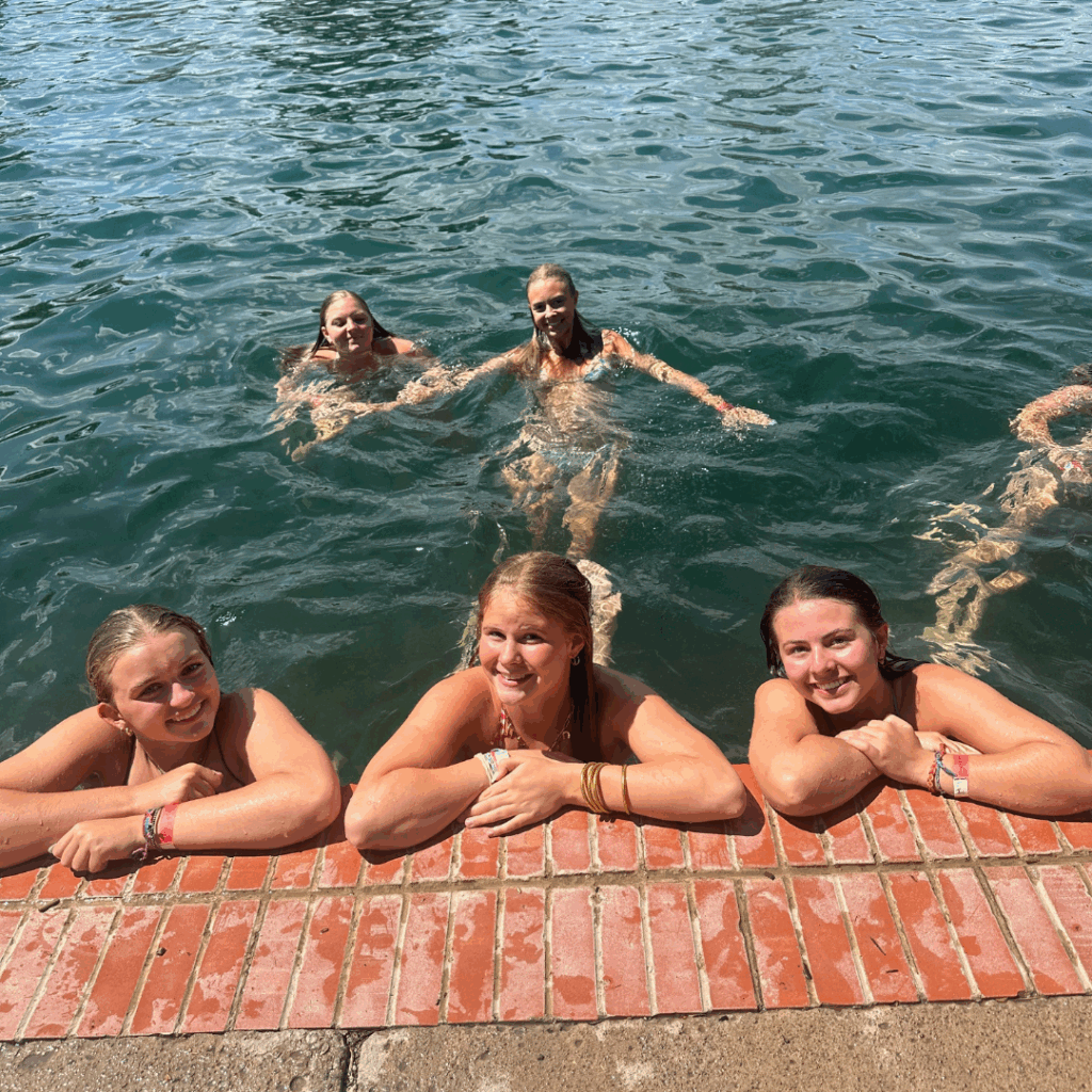 students floating in the pool at the texas watering hole 