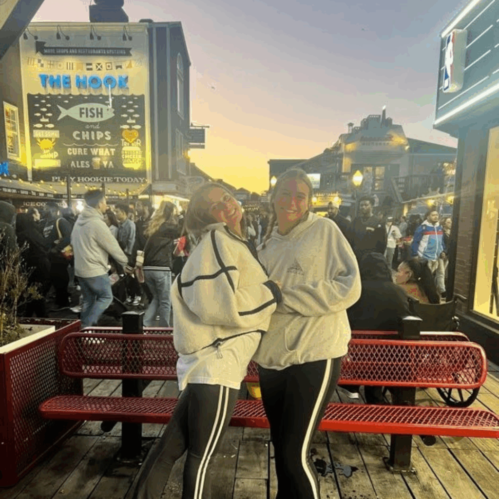 two students hugging at the fish market