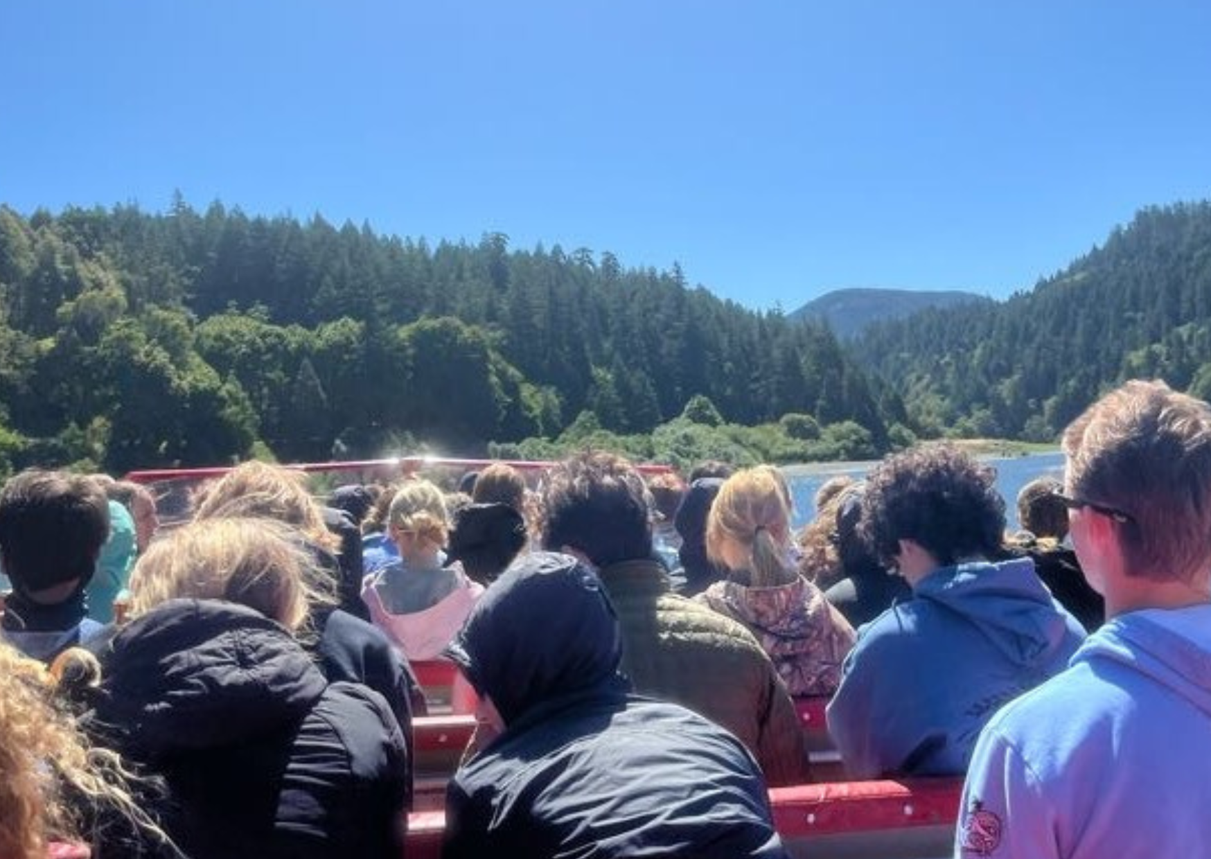 students facing forward on jetboat tour