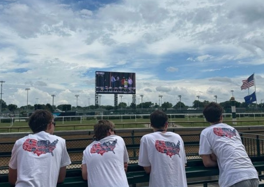 four boys looking at the horse race at churchill downs