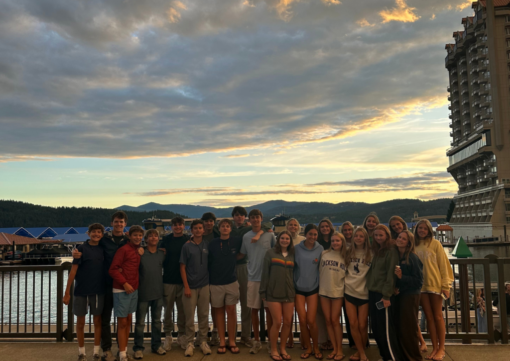 full group of students standing at the waters edge watching sunset in seattle