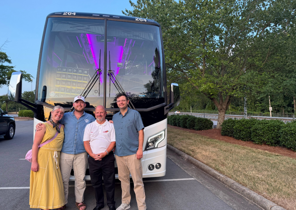 tour leaders and people in front of the tour bus