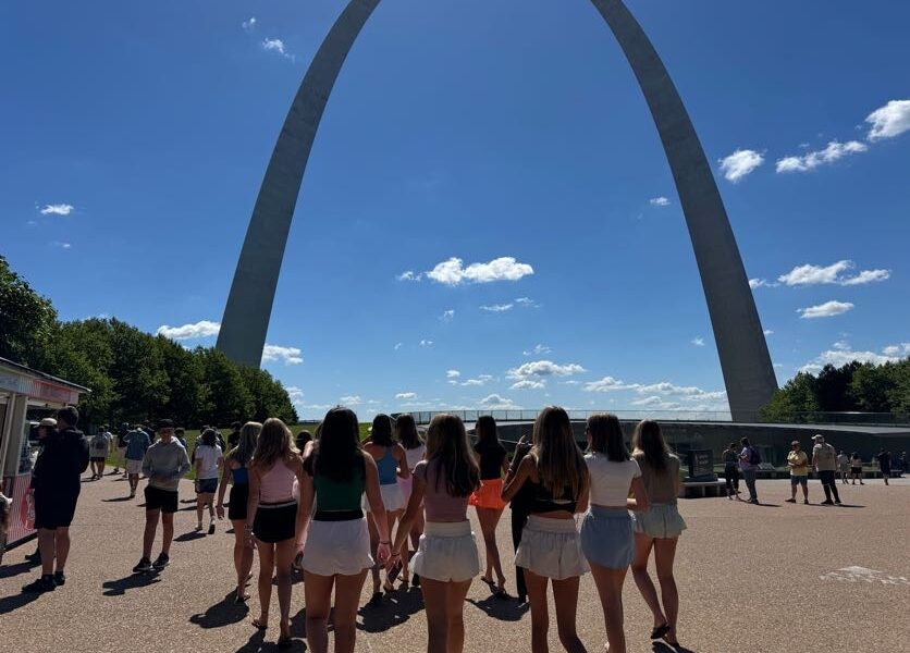 students walking away from camera toward the st louis arch 