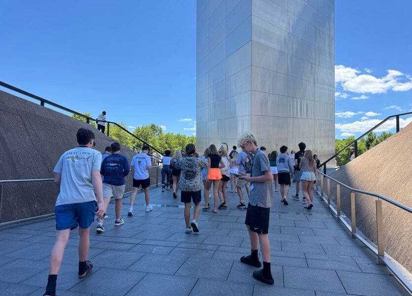 close shot of students walking near the st louis arch