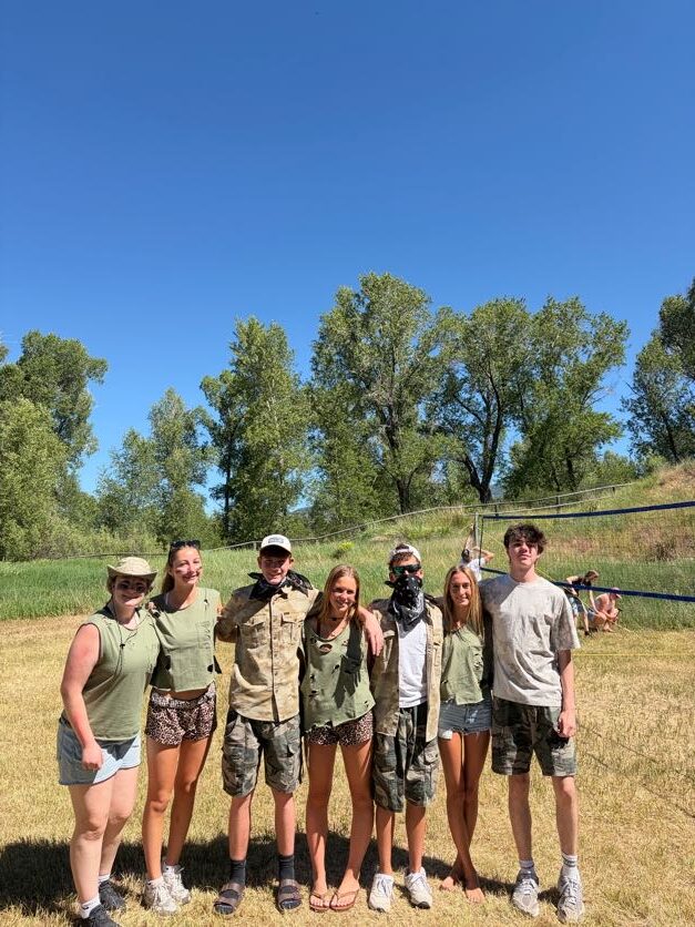 students dressed up in army green in front of the volleyball net in idaho