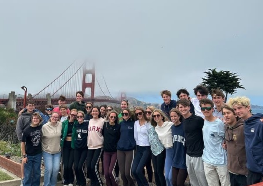 students standing in a line in front of the golden gate bridge