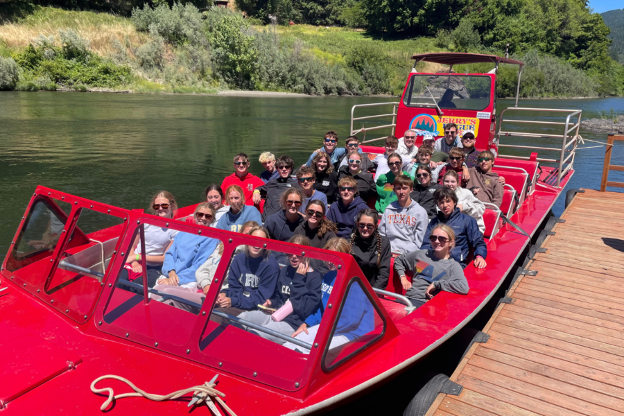 students in a red jet boat in the rogue river