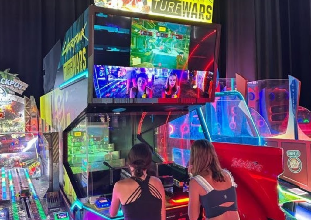 Colorful arcade games with neon lighting inside Dave & Buster's.