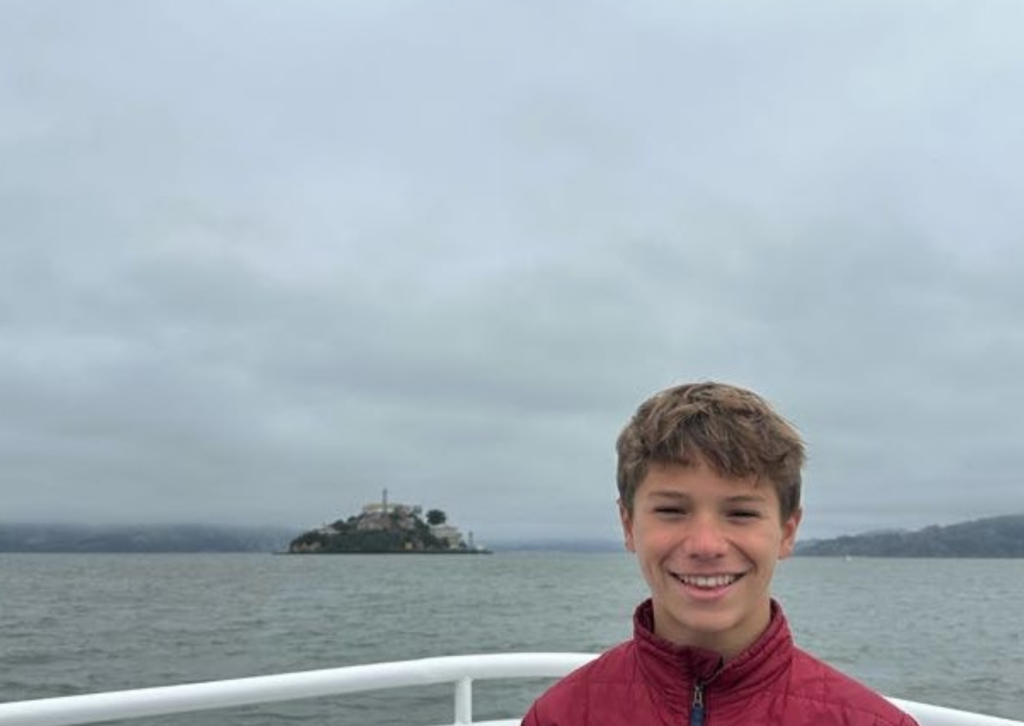boy smiling at wharf from ferry