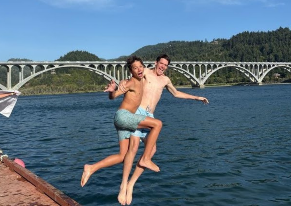 two students jumping into the rogue river in oregon with silly faces