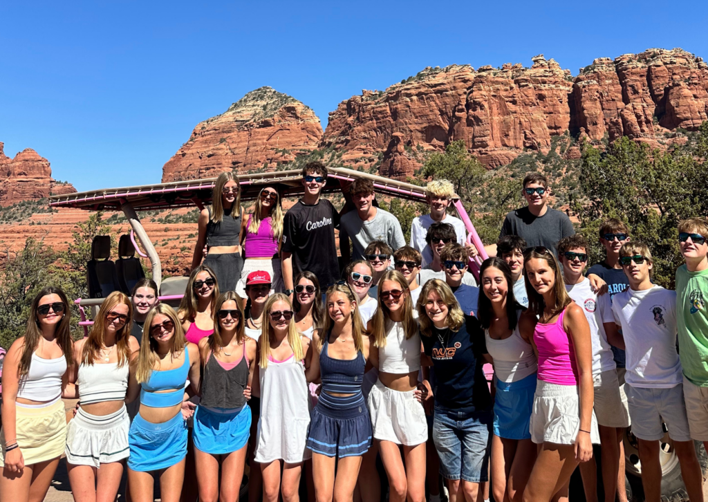 Group photo in front of towering red rock formations in Sedona.
