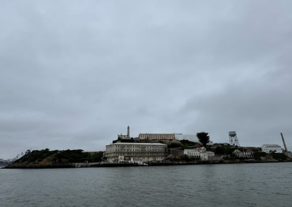 alcatraz island from a distance with water from ferry